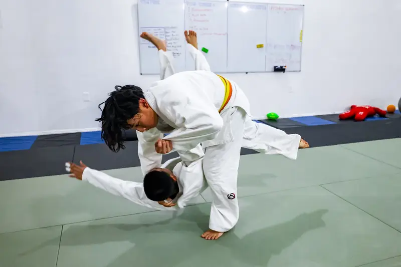 Youth judoka practicing a throw on the mat at Kensei Judo in San Jose