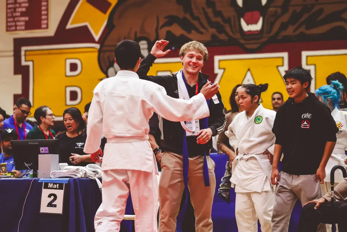 A Kensei student and coach together at an outside judo competition