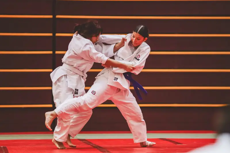 Junior Kensei students practicing a controlled judo throw